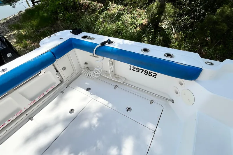 Slide: The Image of 2006 Boston Whaler 285 Conquest boat interior with blue seating and storage compartments. - 17