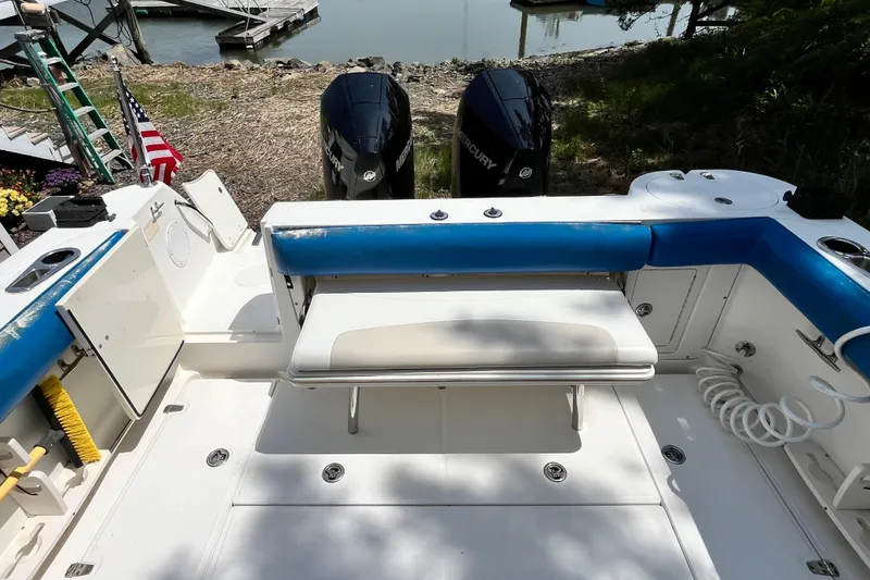 Slide: The Image of 2006 Boston Whaler 285 Conquest boat interior with seating and twin Mercury engines. - 20