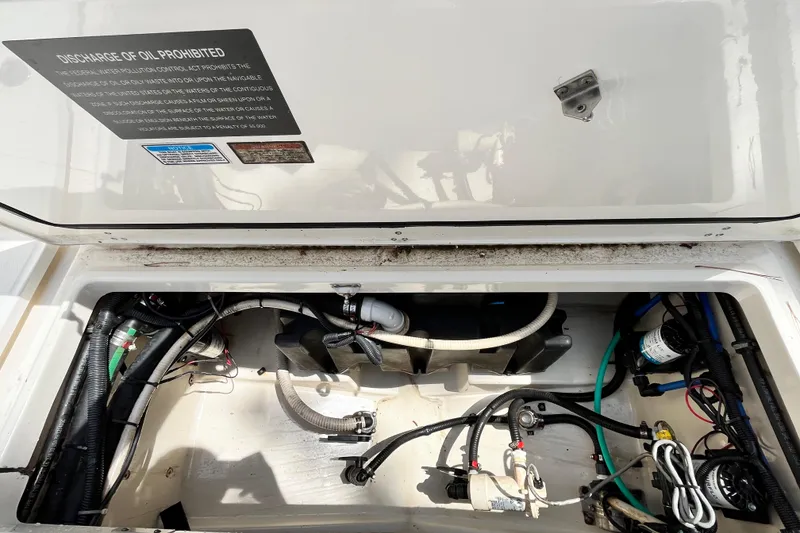 Slide: The Image of Engine compartment of a 2006 Boston Whaler 285 Conquest boat, showing wiring and components. - 21
