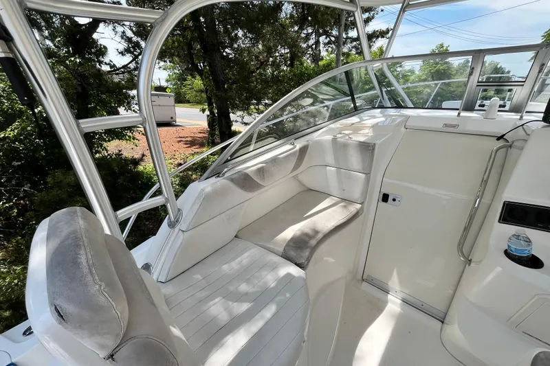 Slide: The Image of 2006 Boston Whaler 285 Conquest interior with cushioned seating and sleek design. - 27