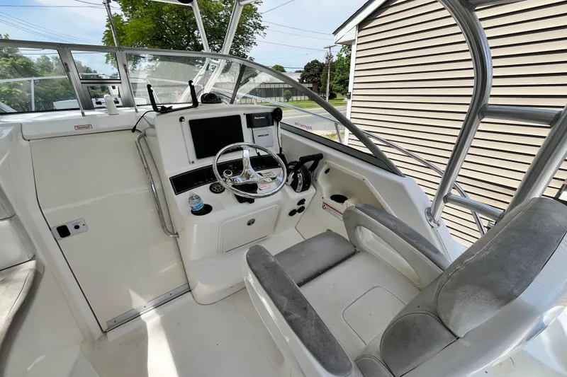 Slide: The Image of 2006 Boston Whaler 285 Conquest helm with steering wheel and navigation equipment. - 29