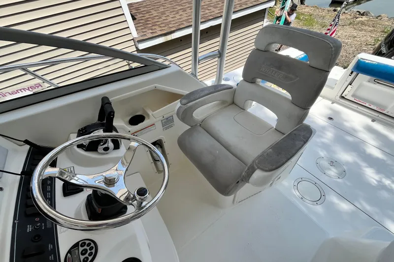 Slide: The Image of Helm of 2006 Boston Whaler 285 Conquest with steering wheel and captain's chair. - 30