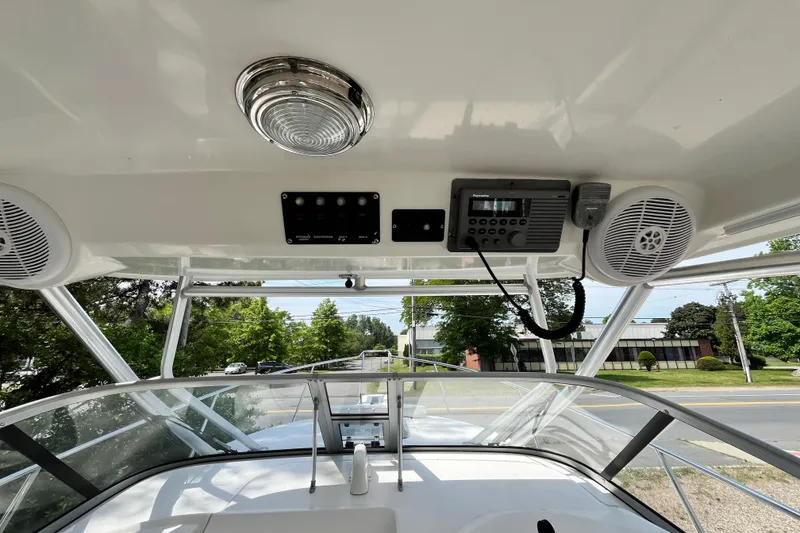 Slide: The Image of 2006 Boston Whaler 285 Conquest helm with electronics and speakers, showcasing modern marine design. - 34