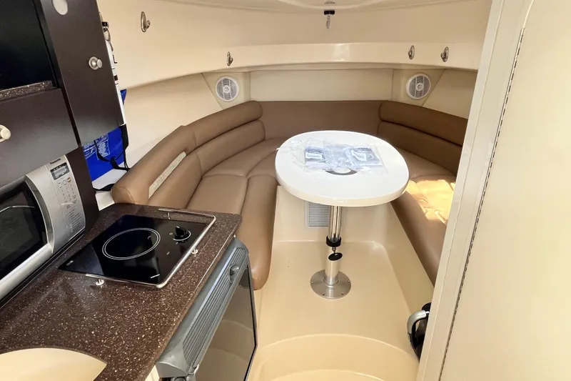 Slide: The Image of Interior of 2006 Boston Whaler 285 Conquest with kitchenette and seating area. - 35