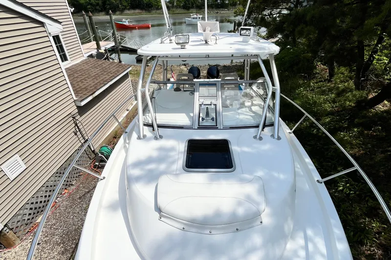 Slide: The Image of 2006 Boston Whaler 285 Conquest boat docked near a house by the water. - 42