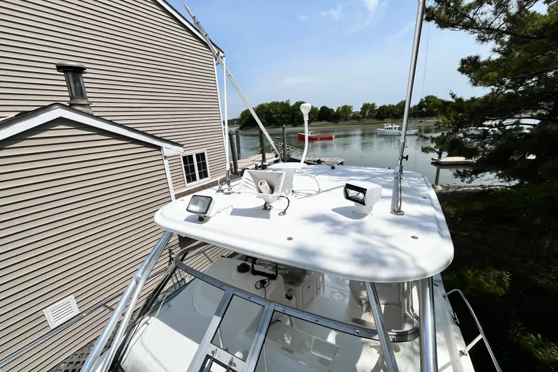 Slide: The Image of 2006 Boston Whaler 285 Conquest boat docked near a house by the water. - 45