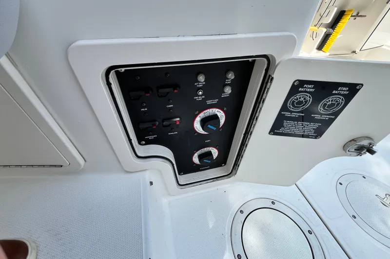 Slide: The Image of Control panel on a 2006 Boston Whaler 285 Conquest boat, featuring battery switches. - 46