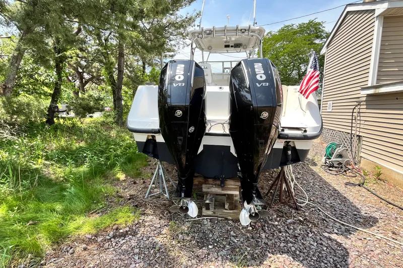 Slide: The Image of 2006 Boston Whaler 285 Conquest boat with dual Mercury 250 V8 engines, parked outdoors. - 47