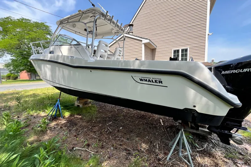 Slide: The Image of 2006 Boston Whaler 285 Conquest boat on stands, side view, outdoors. - 5