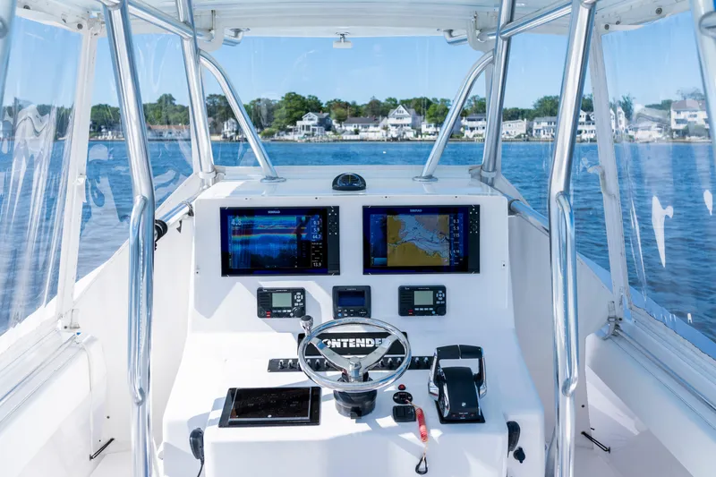 Slide: The Image of Cockpit view of 2015 Contender 39 ST boat with navigation screens and steering wheel. - 1