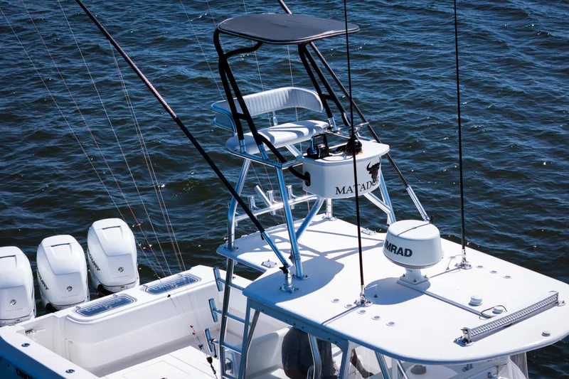 Slide: The Image of 2015 Contender 39 ST boat with tower and multiple outboard engines on the water. - 10