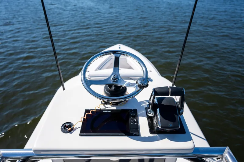 Slide: The Image of Helm of 2015 Contender 39 ST boat with steering wheel and navigation controls. - 14