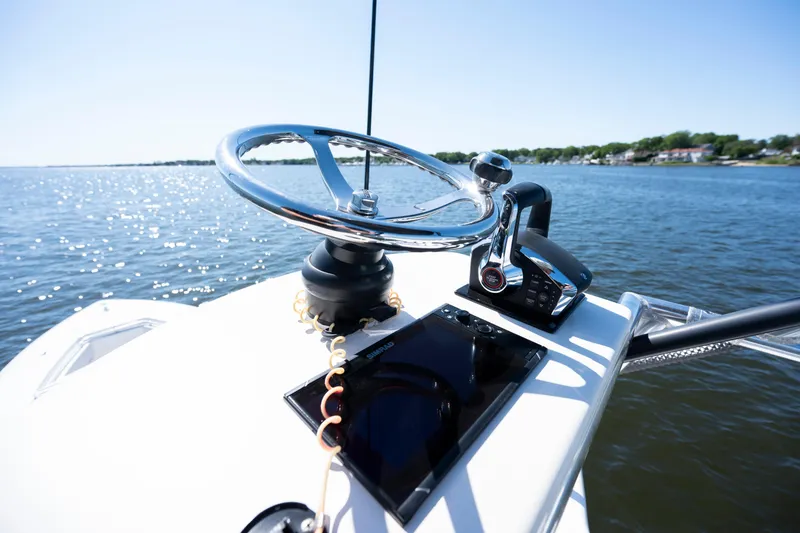 Slide: The Image of Steering console of 2015 Contender 39 ST boat on a sunny day. - 15