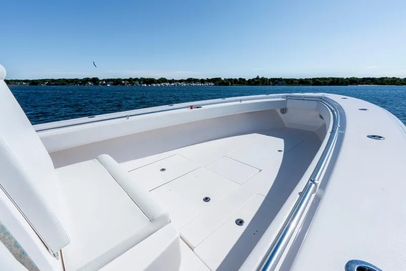 Slide: The Image of 2015 Contender 39 ST boat on calm water, showcasing spacious deck and sleek design. - 17
