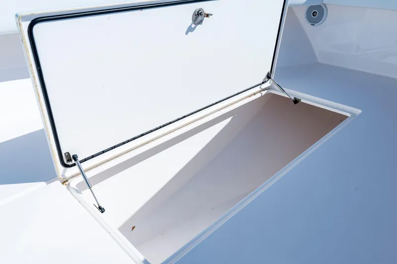 Slide: The Image of Open storage compartment on a 2015 Contender 39 ST boat, showcasing interior space. - 21