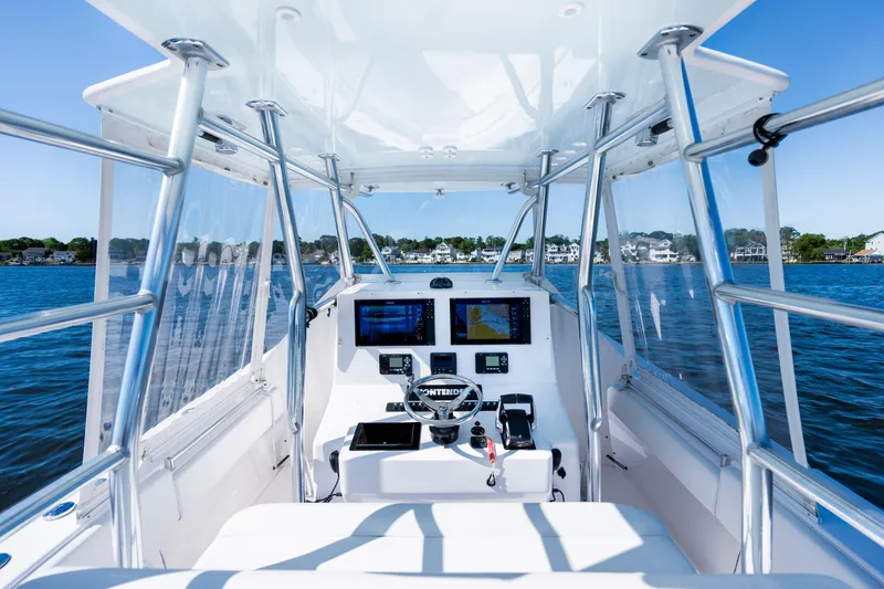 Slide: The Image of 2015 Contender 39 ST boat cockpit with navigation screens on a sunny day. - 25