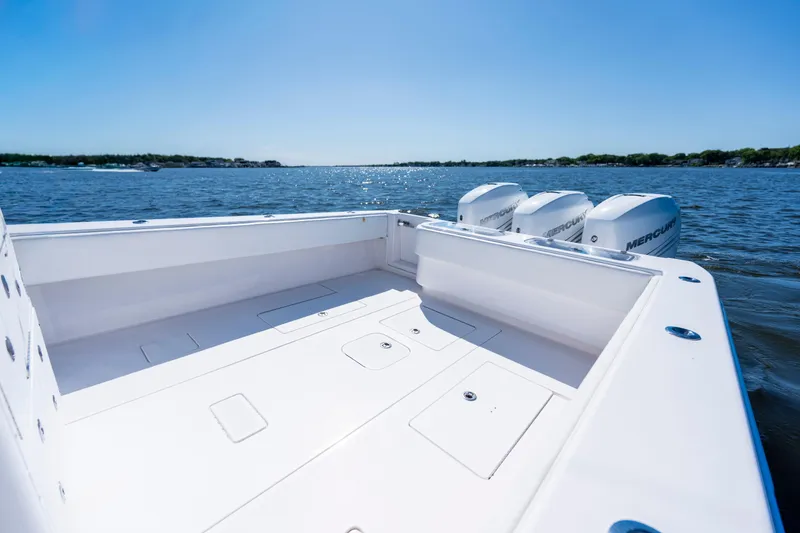 Slide: The Image of 2015 Contender 39 ST boat with triple Mercury engines on open water. - 29