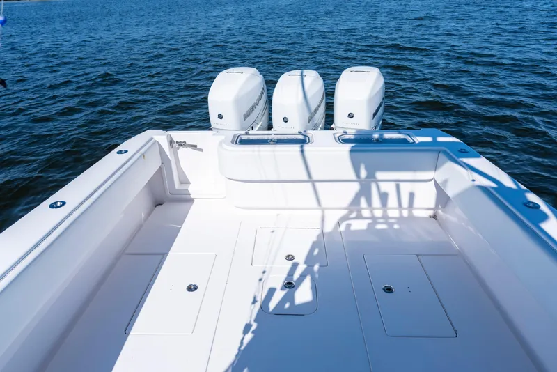 Slide: The Image of 2015 Contender 39 ST boat with triple Mercury engines on open water. - 33