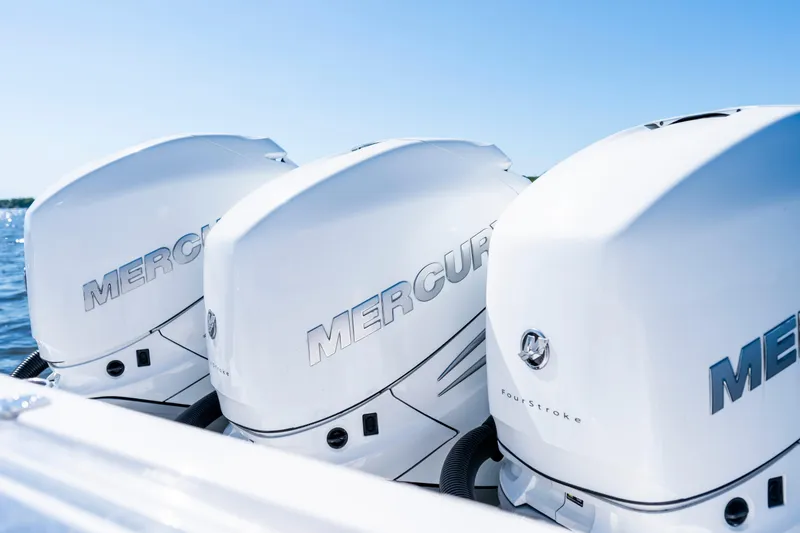Slide: The Image of Triple Mercury outboard engines on a 2015 Contender 39 ST boat. - 34