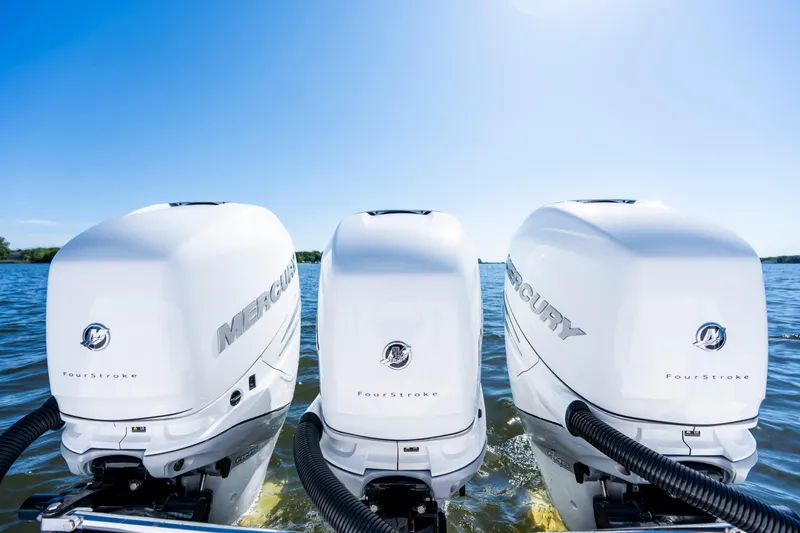 Slide: The Image of Triple Mercury FourStroke engines on a 2015 Contender 39 ST boat in open water. - 36