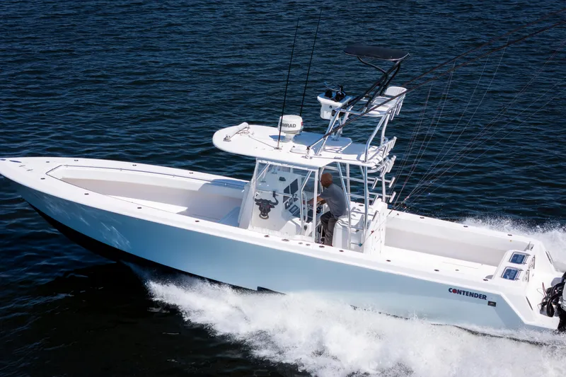Slide: The Image of 2015 Contender 39 ST boat cruising on open water, showcasing sleek design and performance. - 7