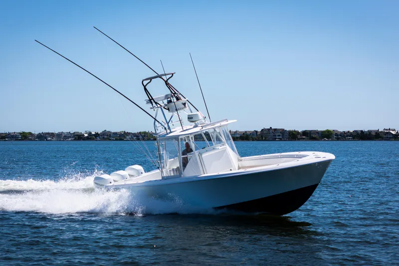 Slide: The Image of 2015 Contender 39 ST boat cruising on open water under clear blue sky. - 8
