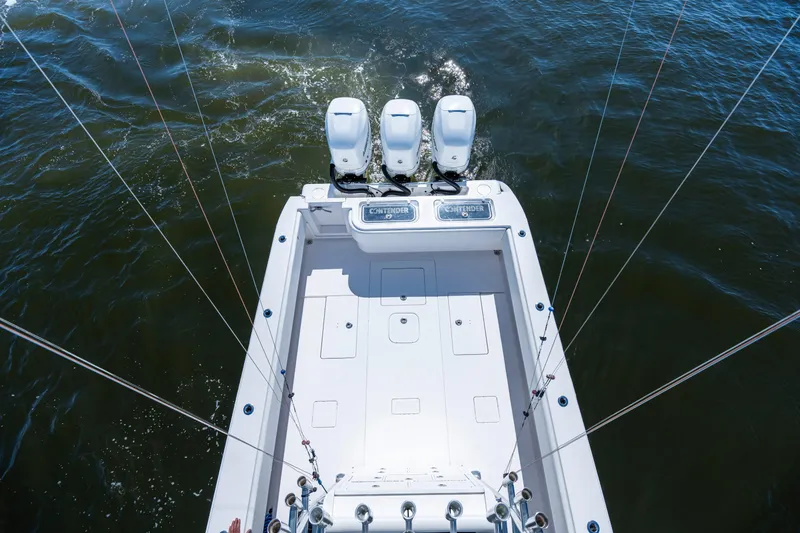 Slide: The Image of 2015 Contender 39 ST boat with triple engines on open water. - 9
