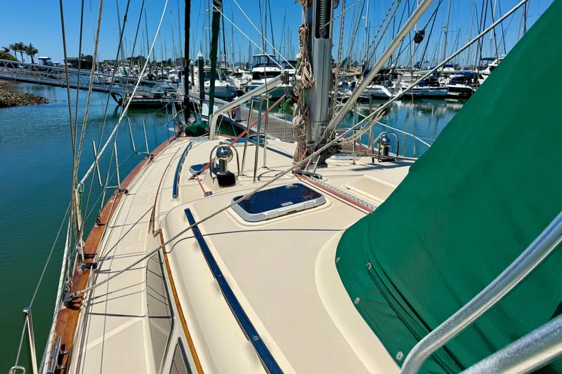 Slide: The Image of 2003 Island Packet 485 sailboat docked in a marina, showcasing deck and rigging. - 13