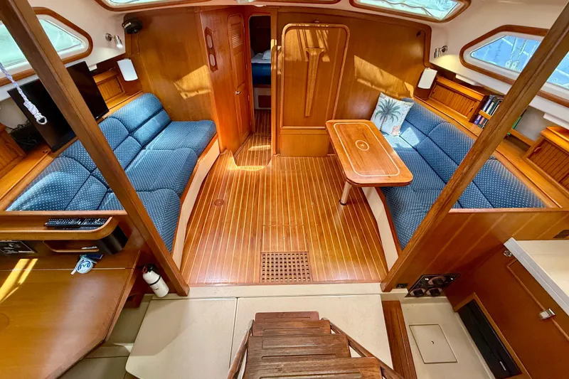 Slide: The Image of Luxurious 2006 Island Packet 485 yacht interior with wooden finish and blue seating. - 16