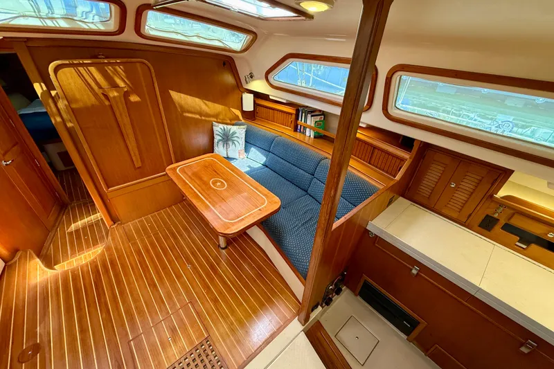 Slide: The Image of Luxurious 2006 Island Packet 485 yacht interior with wood finish and cozy seating area. - 17