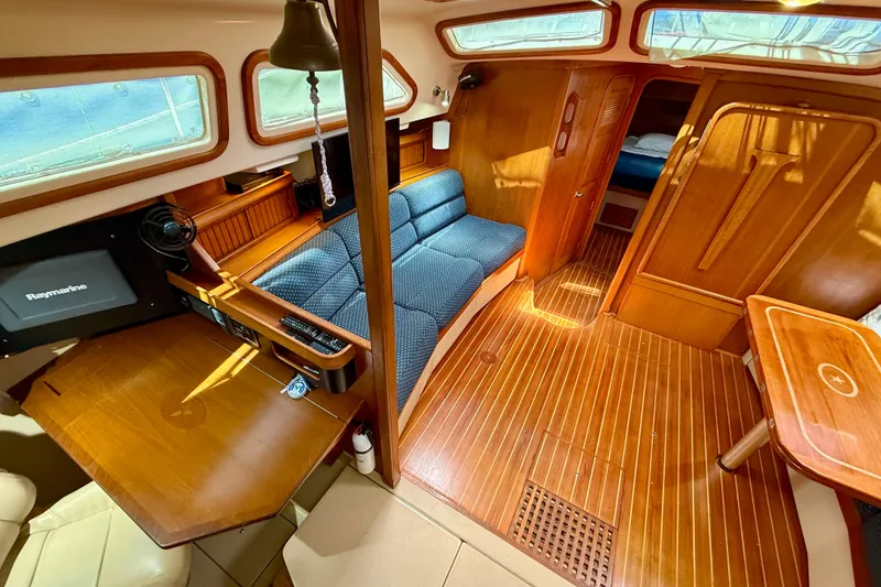 Slide: The Image of Interior of 2006 Island Packet 485 yacht with wooden furnishings and blue seating. - 18