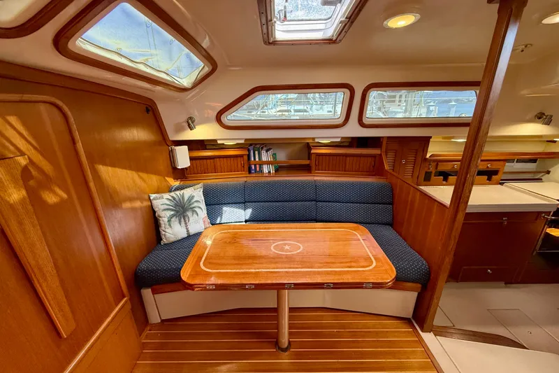 Slide: The Image of Interior of 2006 Island Packet 485 yacht with cozy seating and wooden table. - 22