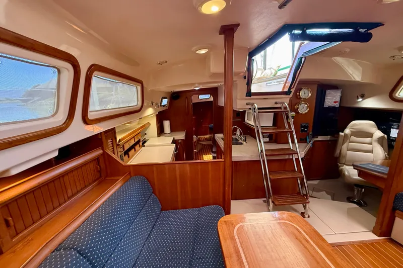 Slide: The Image of Interior of 2006 Island Packet 485 yacht, featuring elegant wood finishes and comfortable seating. - 23