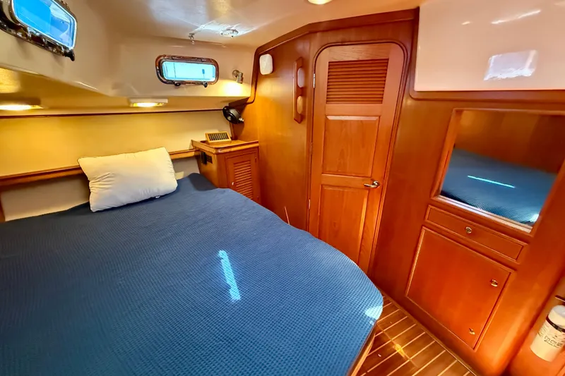 Slide: The Image of Luxurious 2006 Island Packet 485 yacht cabin with cozy bed and wooden interior. - 34