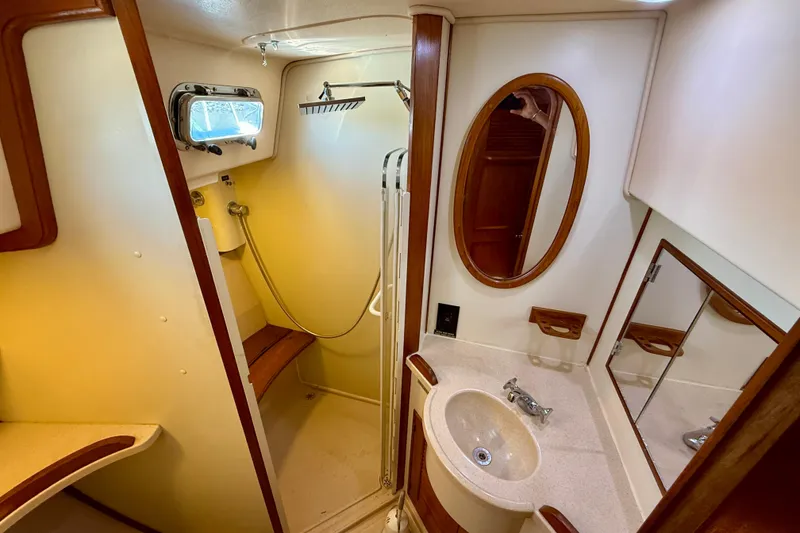 Slide: The Image of 2006 Island Packet 485 yacht bathroom with shower, sink, and mirror. - 37
