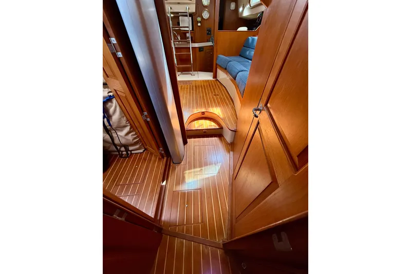 Slide: The Image of Interior of 2006 Island Packet 485 yacht, featuring polished wood flooring and cozy seating. - 44