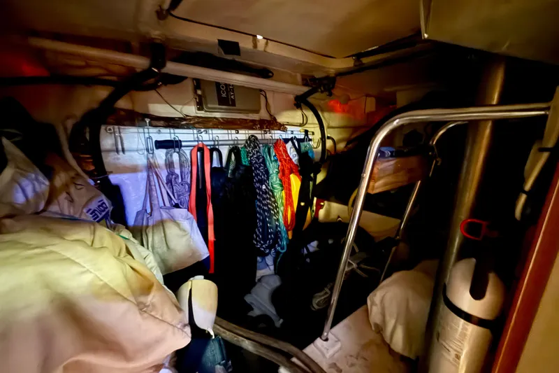 Slide: The Image of Interior storage area of a 2006 Island Packet 485 yacht, featuring hanging gear and equipment. - 51
