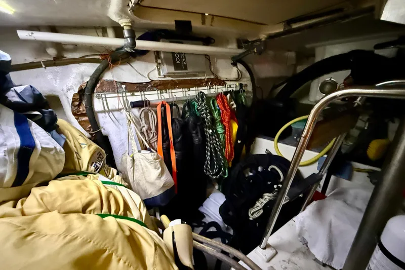 Slide: The Image of Interior of 2006 Island Packet 485 sailboat with ropes and gear storage. - 52