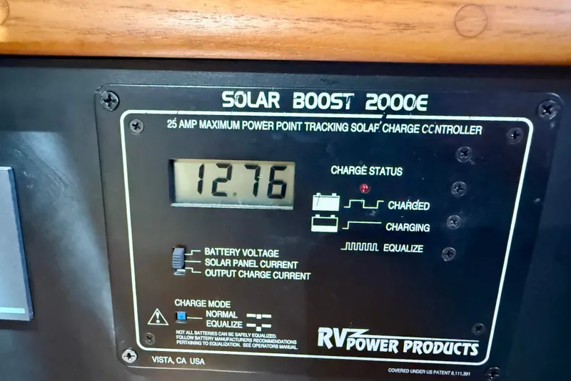 Slide: The Image of Solar Boost 2000E charge controller displaying 12.76 volts on Island Packet 485, 2006 model. - 57