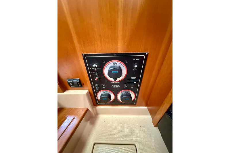Slide: The Image of Control panel of a 2006 Island Packet 485 yacht, featuring switches and dials. - 58