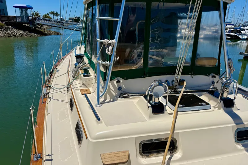 Slide: The Image of 2003 Island Packet 485 sailboat docked in a marina, showcasing deck and rigging details. - 61