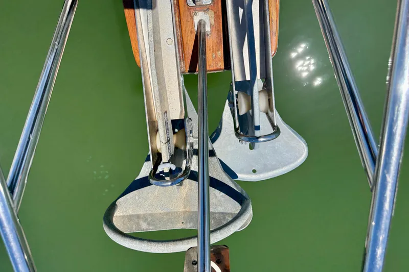 Slide: The Image of Top view of 2003 Island Packet 485 sailboat anchors over green water. - 63