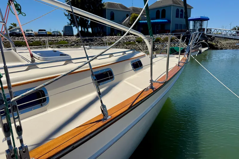 Slide: The Image of 2003 Island Packet 485 sailboat docked, showcasing sleek design and polished wood accents. - 66