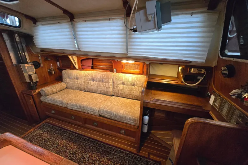 Slide: The Image of Interior of 1979 Islander Freeport 36 sailboat with cozy seating and wooden accents. - 20