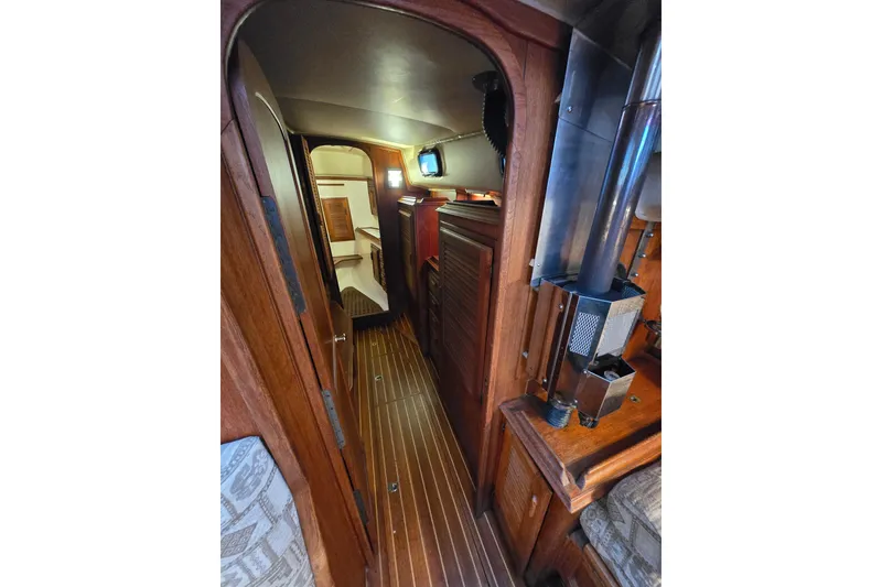Slide: The Image of Interior view of 1979 Islander Freeport 36 sailboat, featuring wood paneling and compact design. - 22