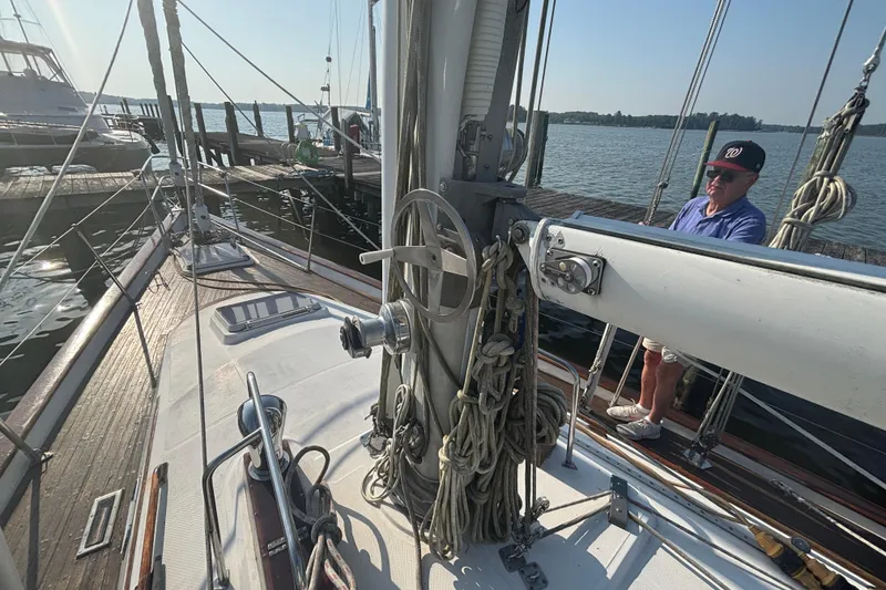 Slide: The Image of Sailing yacht Tayana 52, 1988 model, docked with a person on deck. - 38