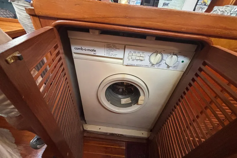Slide: The Image of Washing machine inside 1988 Tayana 52 yacht, wooden cabinetry, Comb-o-matic 747 model. - 66