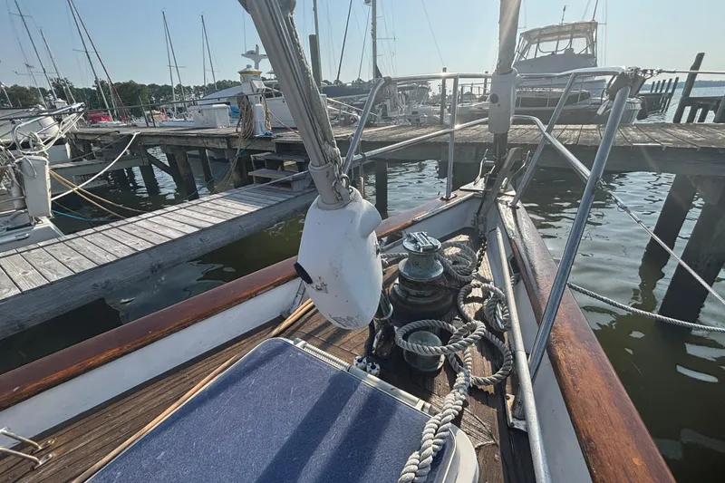 Slide: The Image of 1988 Tayana 52 sailboat docked at marina, showcasing deck and rigging details. - 40