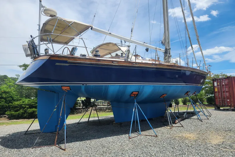 Slide: The Image of 1988 Tayana 52 sailboat on stands, blue hull, sunny day, gravel yard. - 3