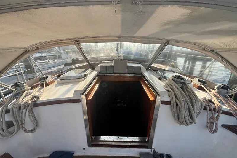 Slide: The Image of Cockpit of 1988 Tayana 52 sailboat with ropes and hatch, docked at marina. - 34